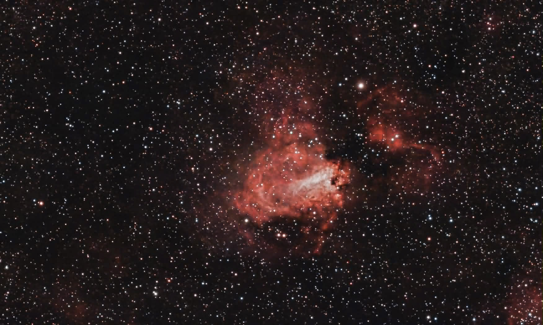 A close-up astrophotograph of a glowing red nebula, shot and printed by Shawn